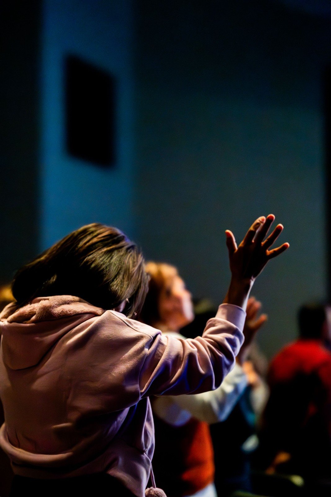 A worshipper with open arms during a Sunday service